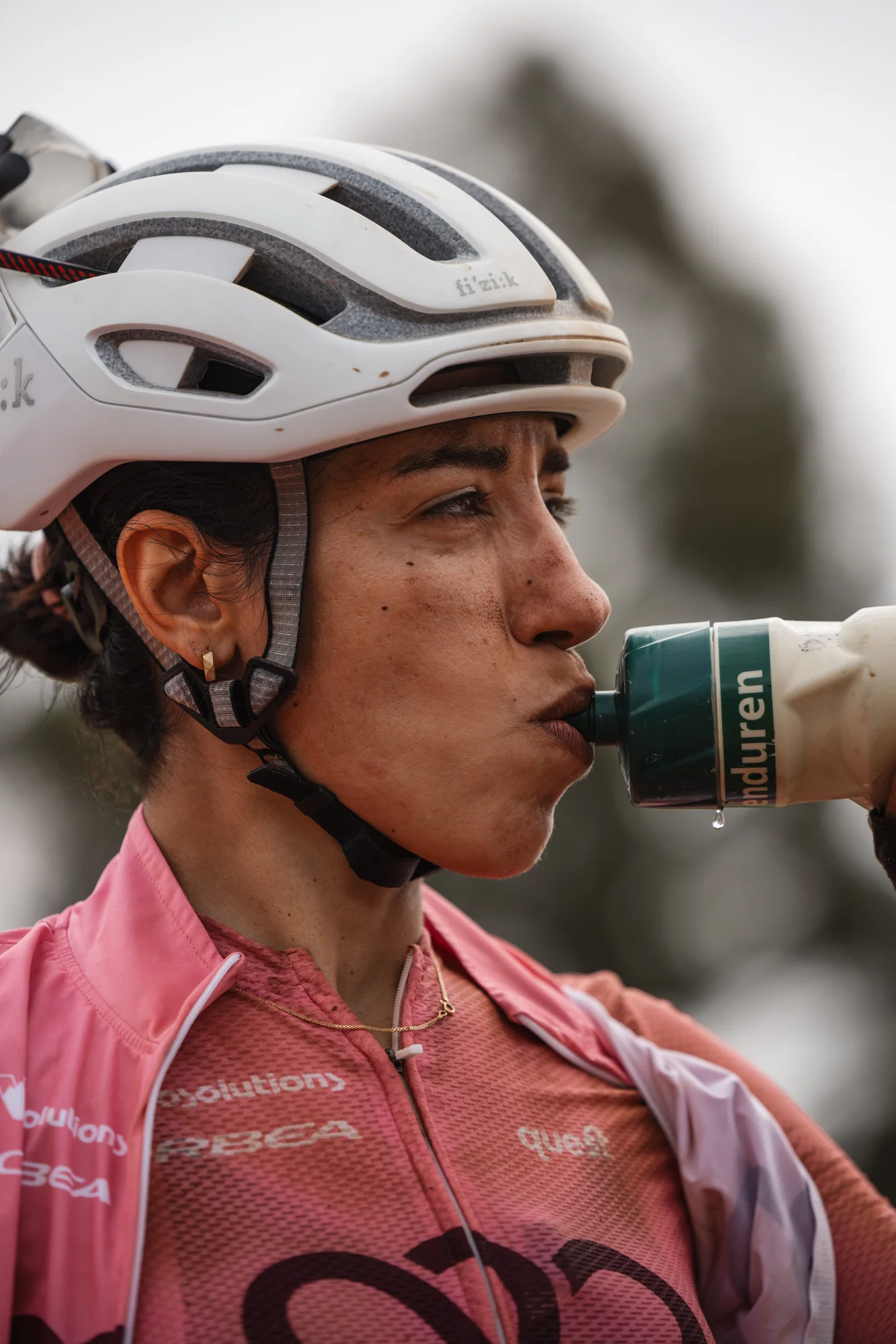 A rider drinking from a bottle
