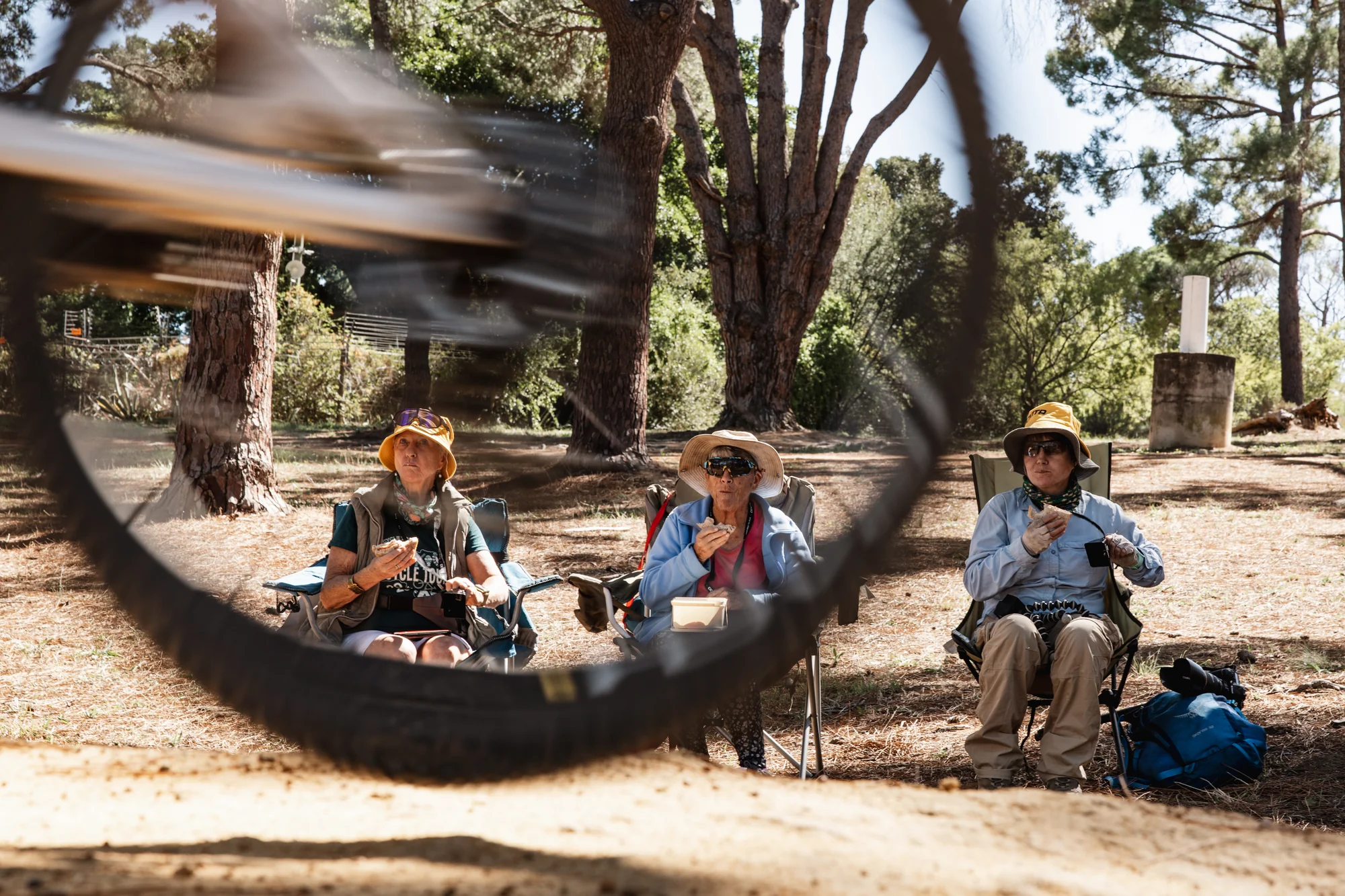 Local children on bicycles, riders passing by
