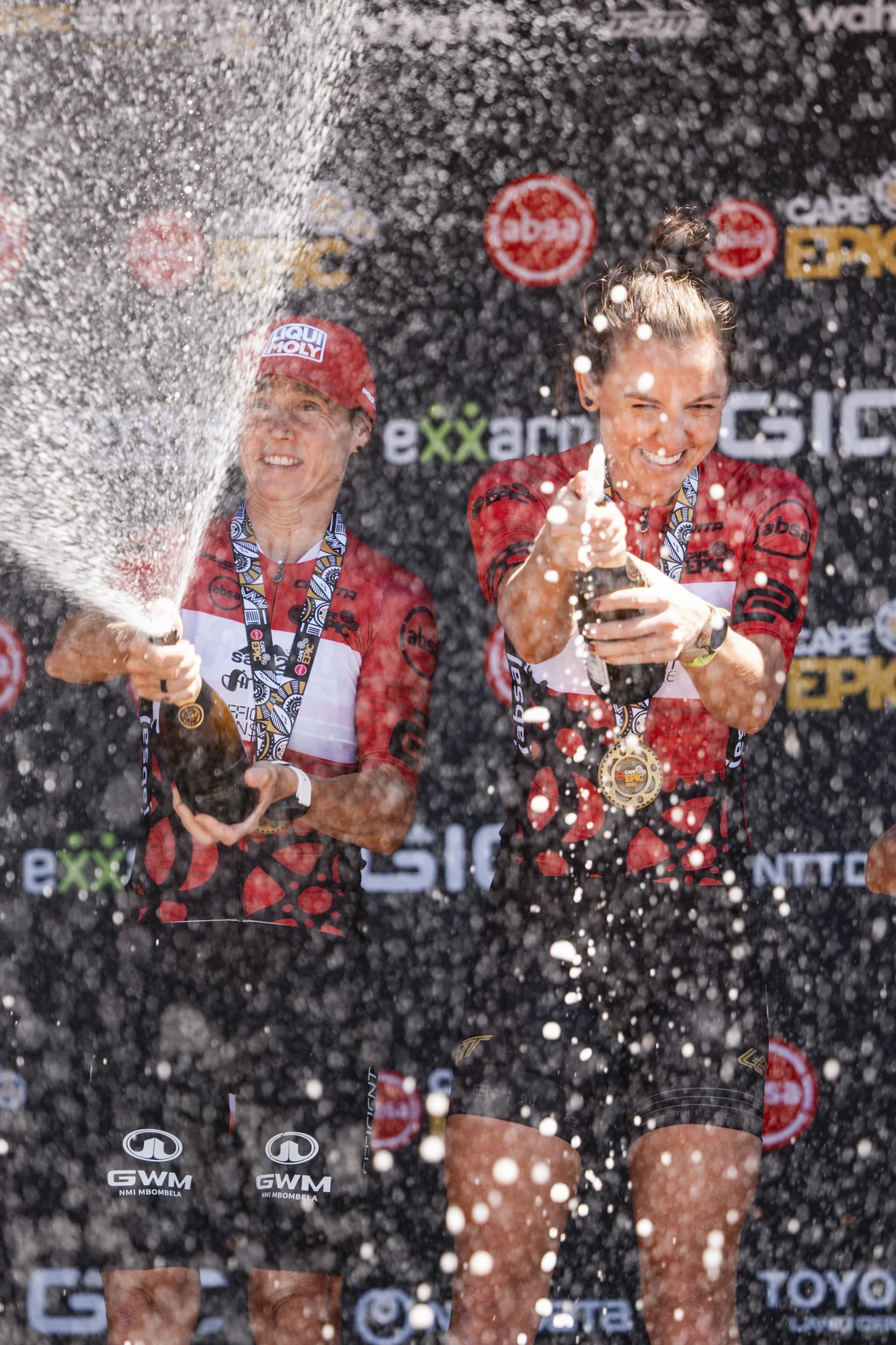 A rider spraying champagne in celebration