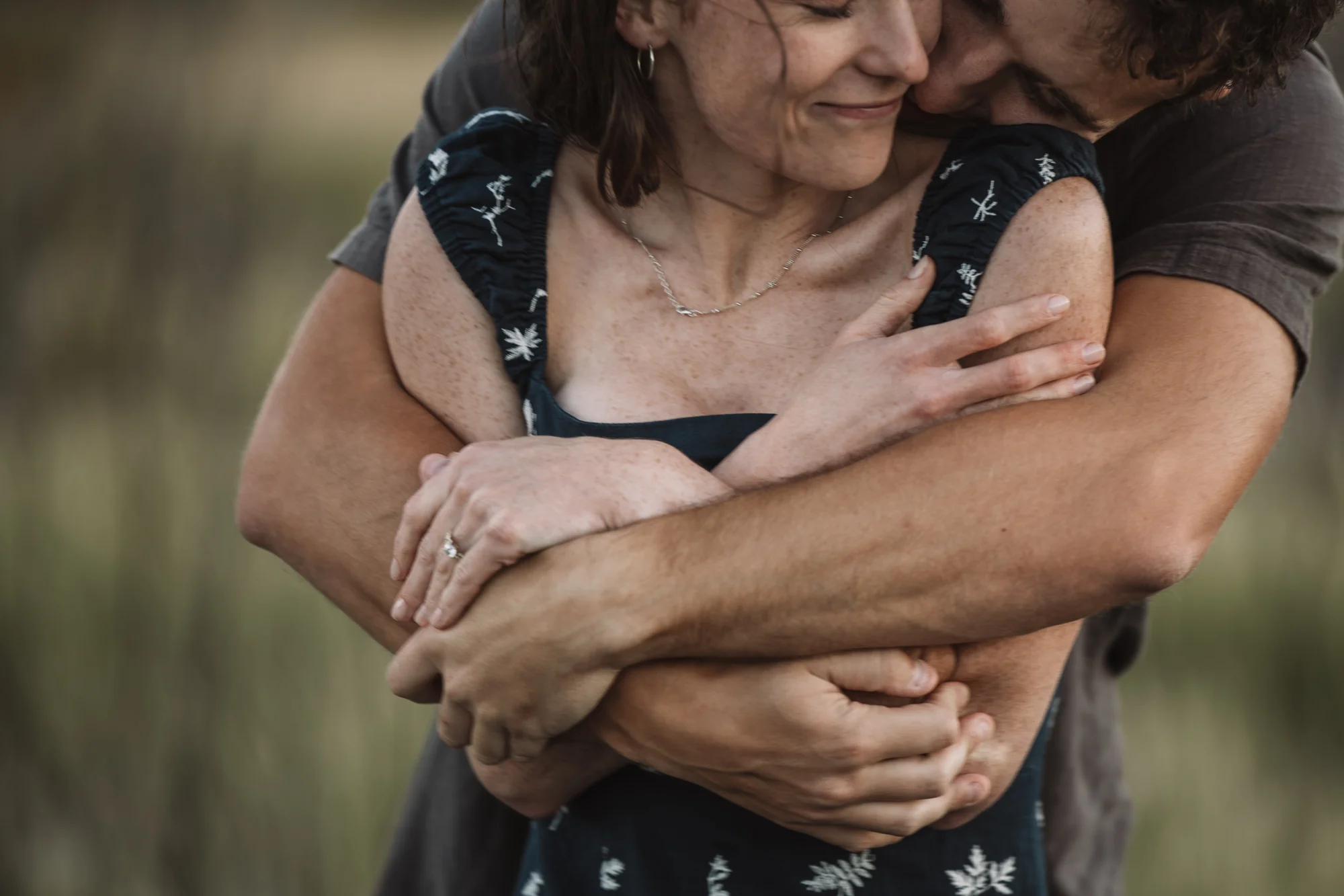 A couple share a close embrace.