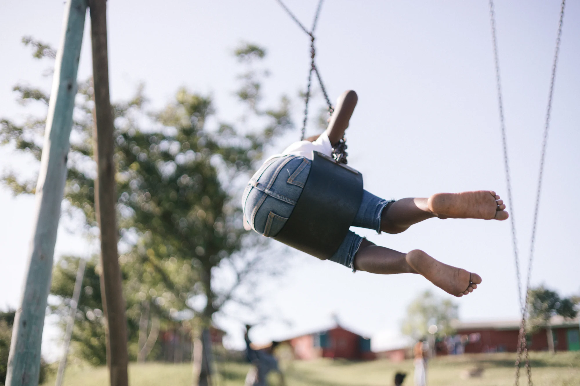 A child mid-air on a swing