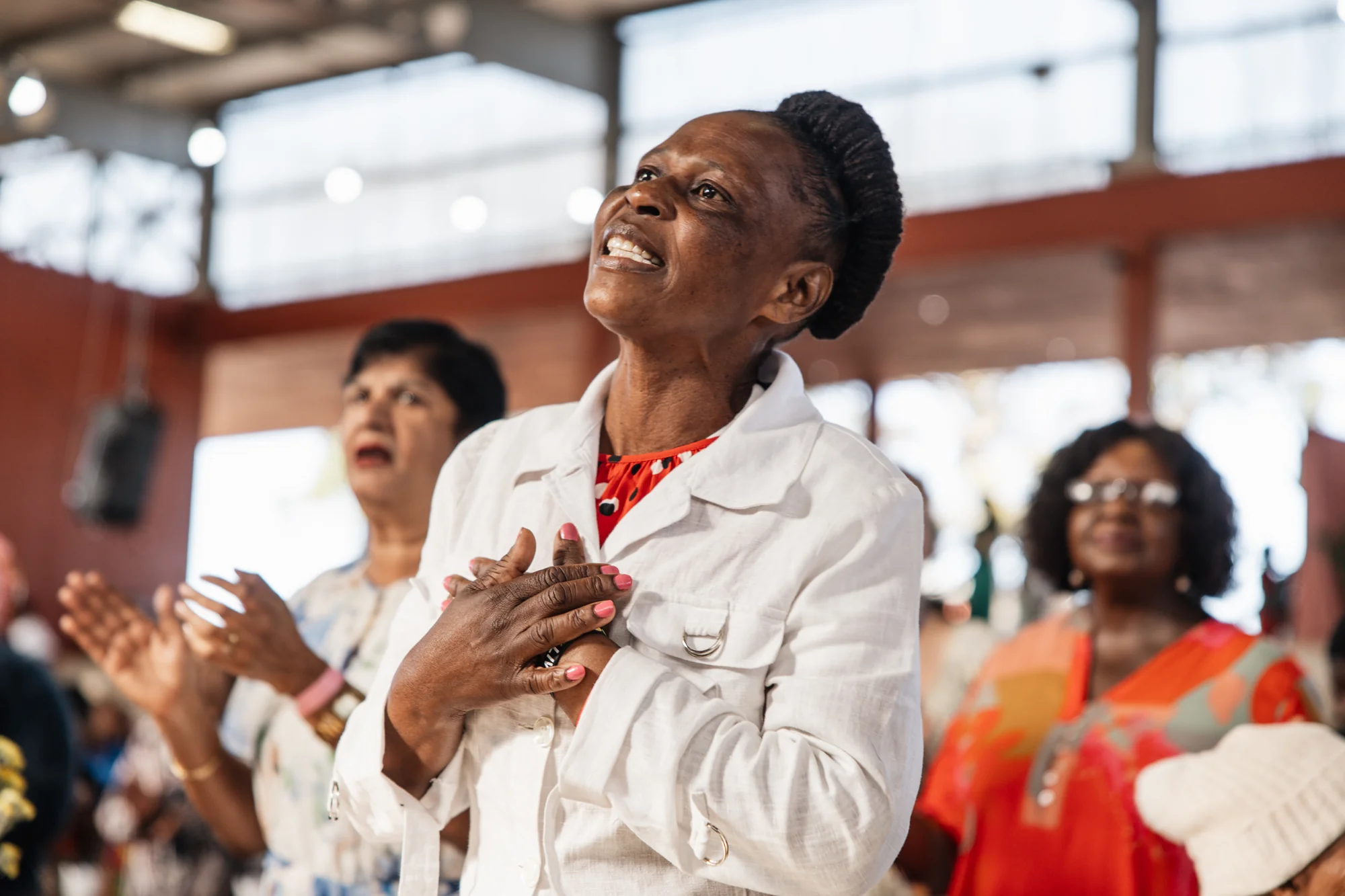 Women clapping together at the conference