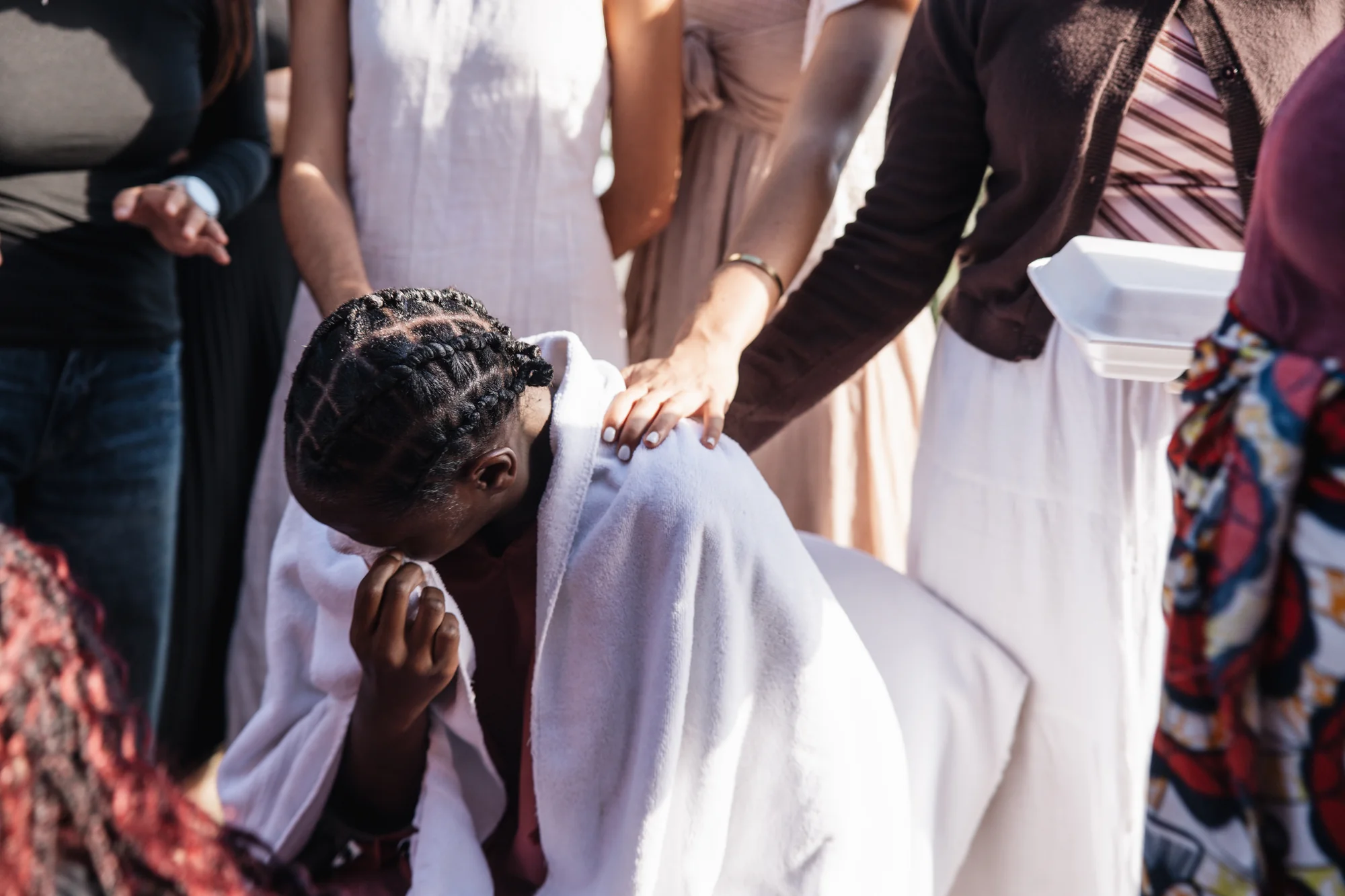 A blessing moment, hands resting on shoulders