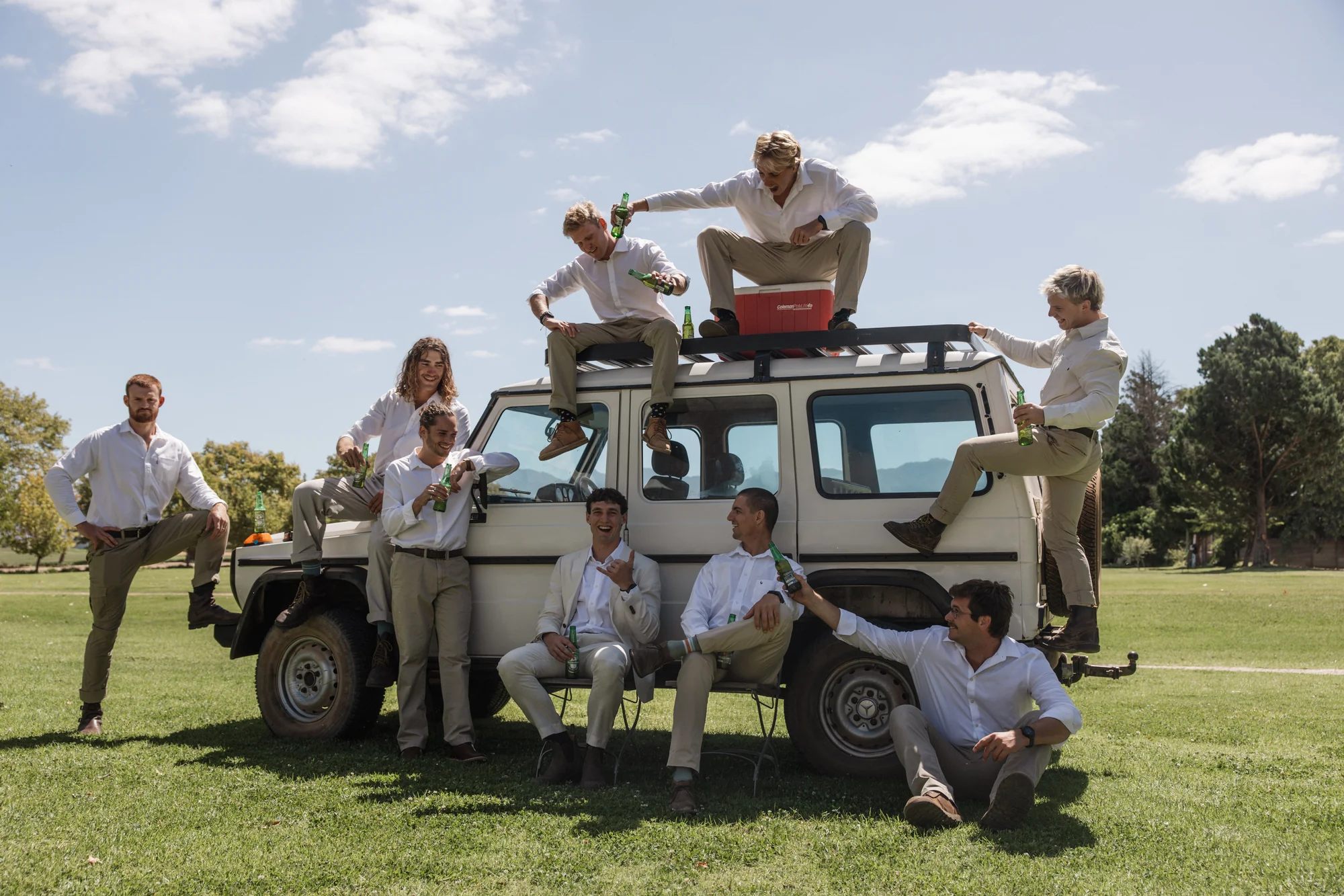 Groomsmen gathered on a Land Rover