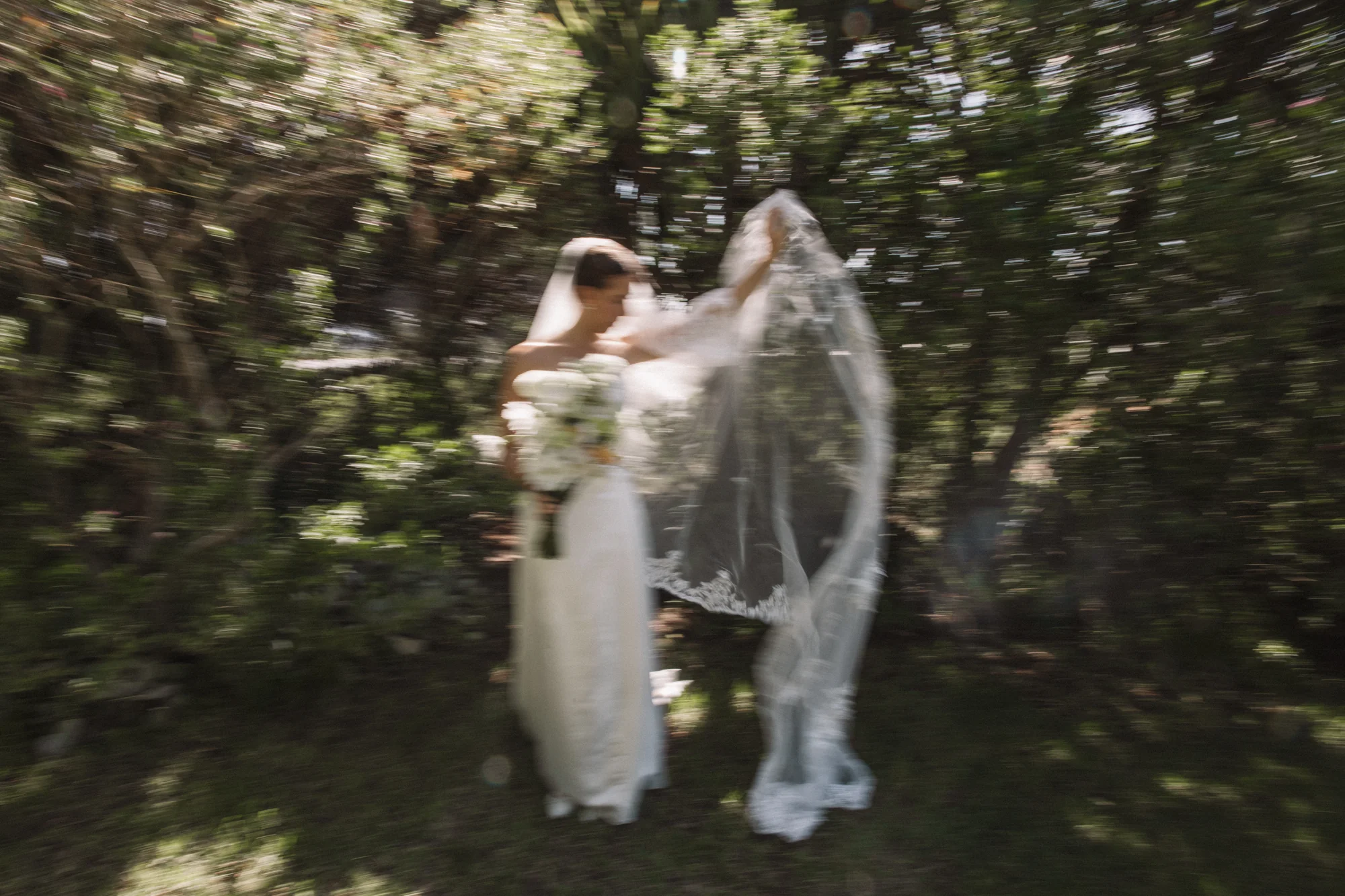 The bride playful beneath the veil