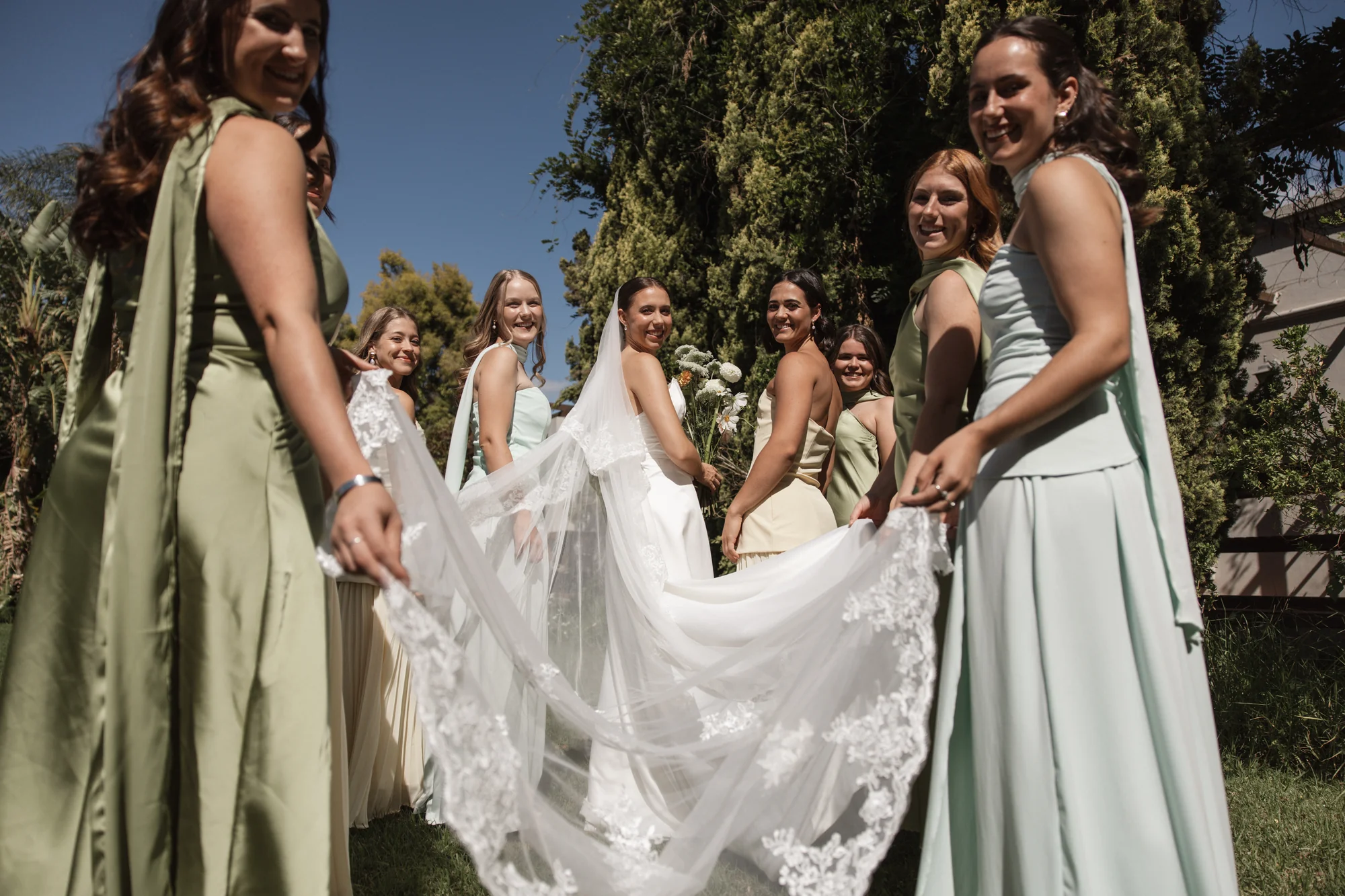 The veil tossed in the wind by the bridesmaids
