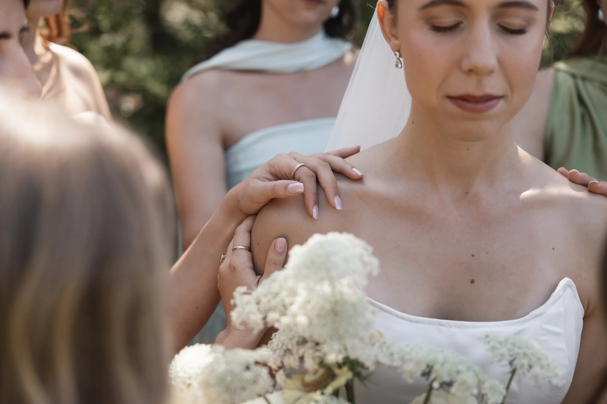 The bride adjusting an earring, a quiet moment