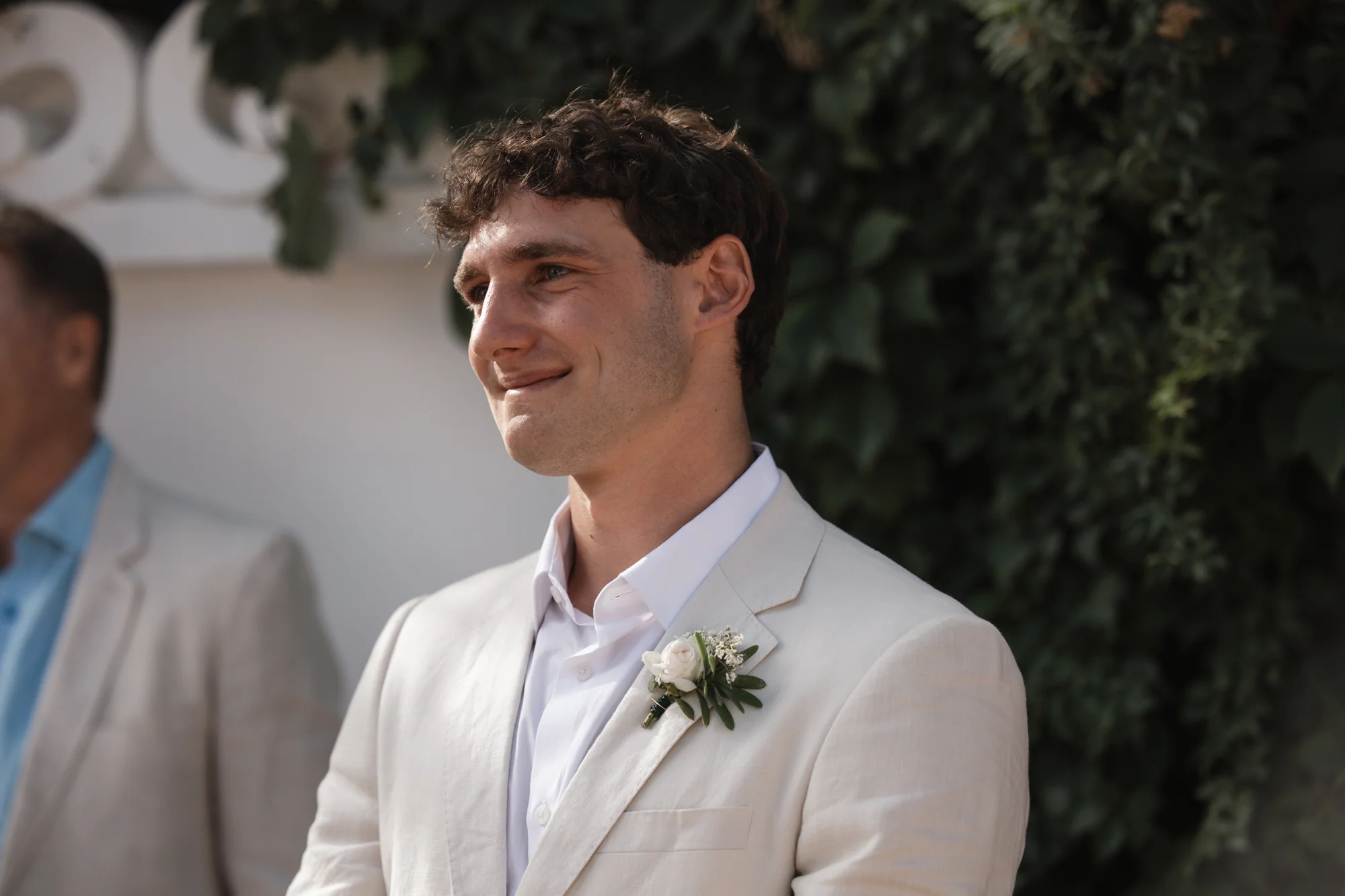 The groom, candid, smiling