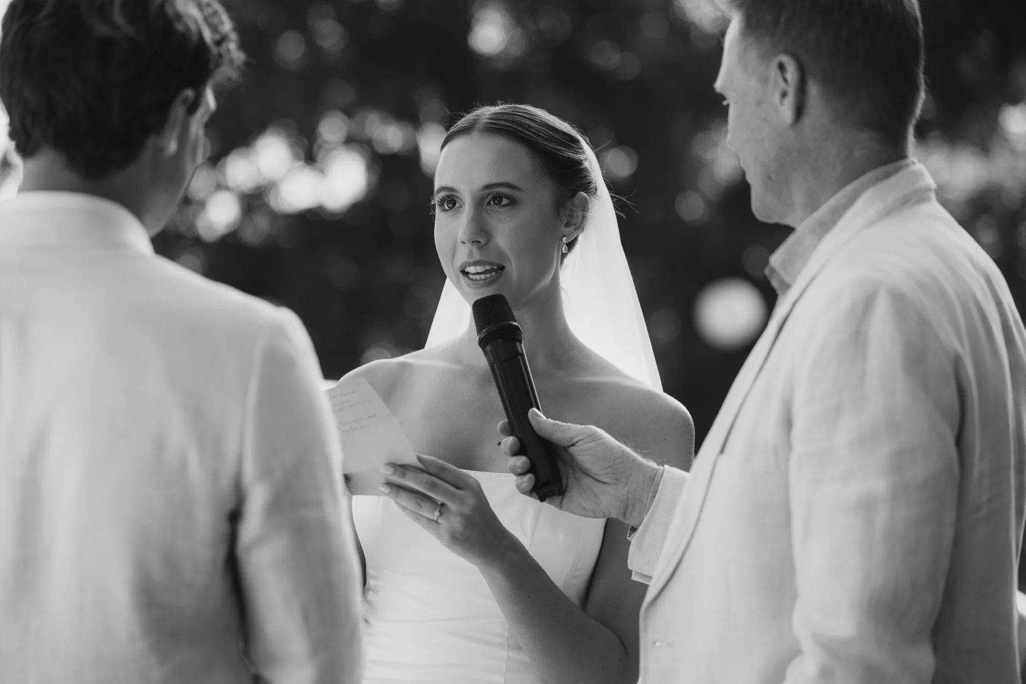 The officiant and the couple, black and white