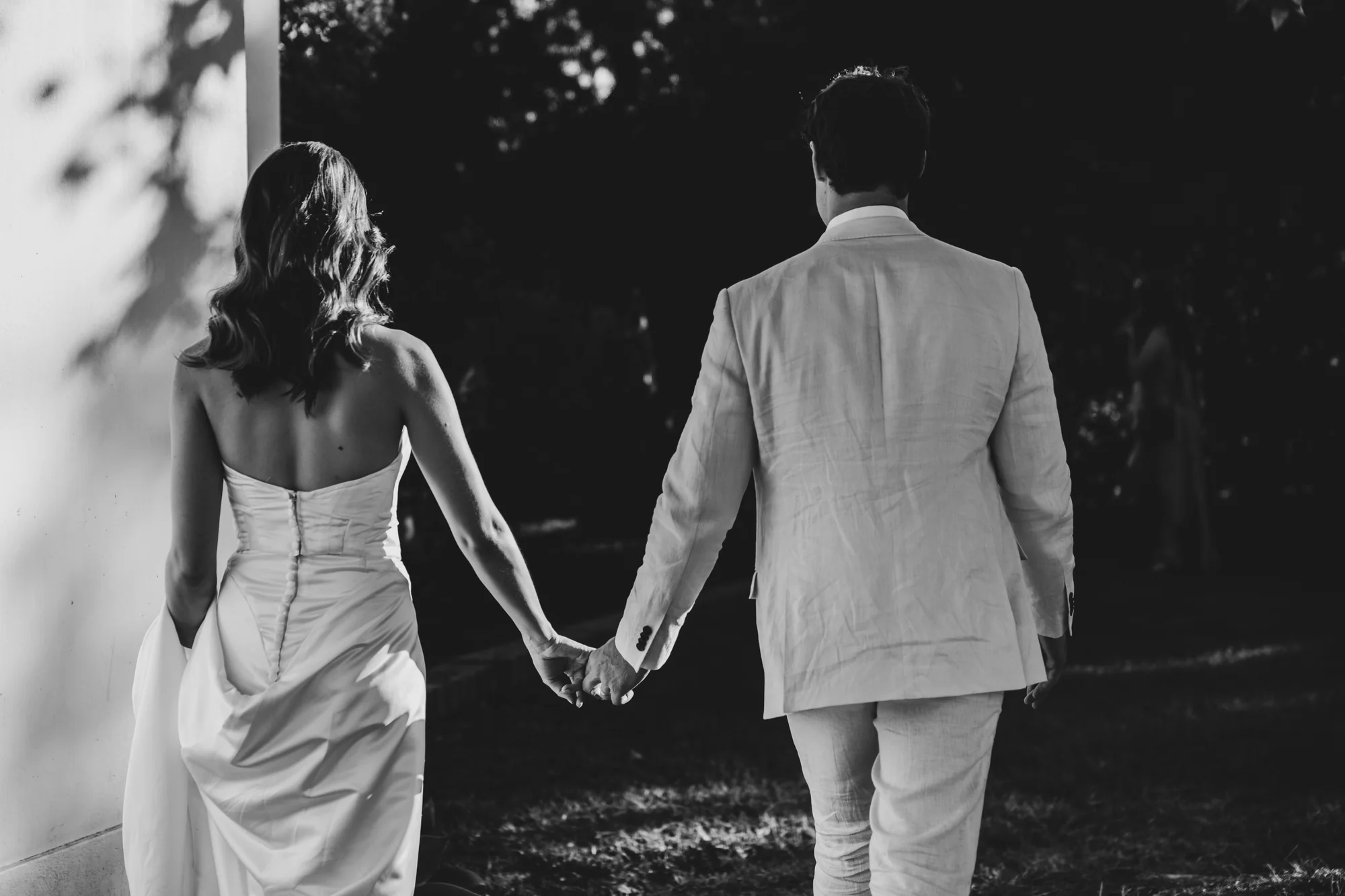 Walking away together, hand in hand, black and white